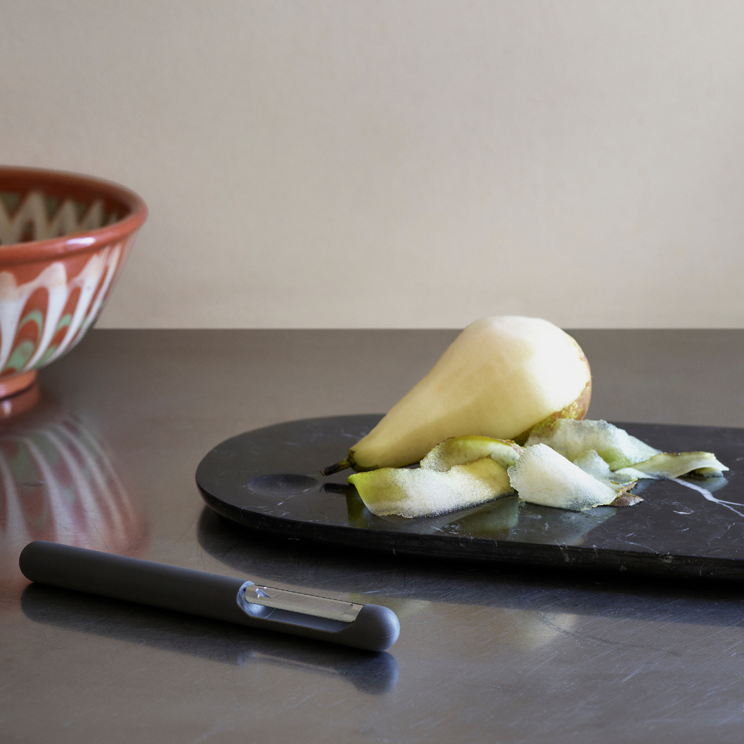 The Pebble Board in Small by Normann Copenhagen is the perfect addition to any home's kitchen decor. Made from a beautiful black marble with white and grey veining, the Pebble Board is a great way to serve up a selection of cheeses and other charcuterie, and it looks beautiful when styled with your most loved breakfast fruits and baked goods.