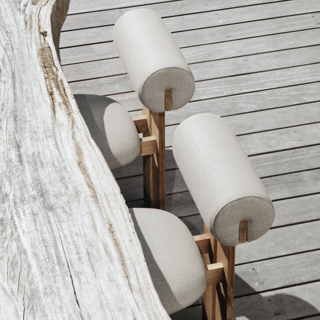 Modern outdoor chair with cylindrical seat back on a wooden deck