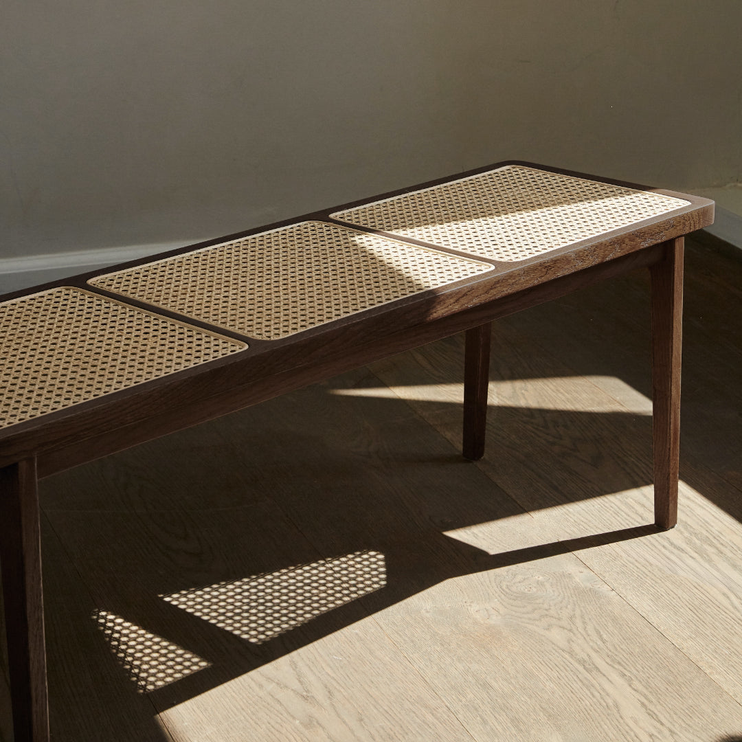 Le Roi Bench Dark Smoked Ash closeup with sun shining on seat
