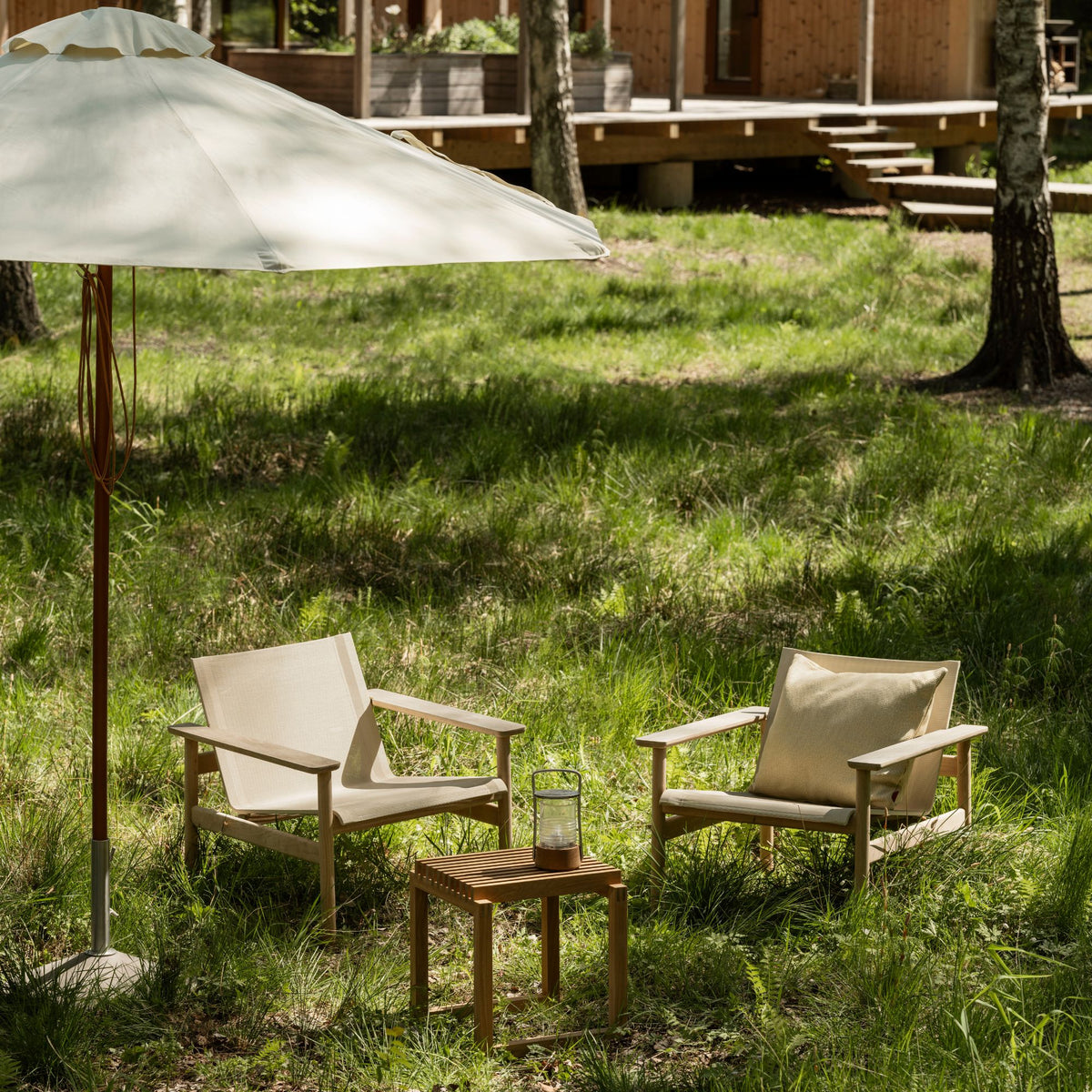 skagerak pelagus outdoor lounge chair with cutter stool and messina umbrella