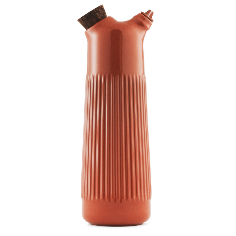 The Junto Vinegar Bottle by Normann Copenhagen was inspired by traditional Spanish ceramics in a beautiful fired terracotta. We love the organic shape of the handmade stoneware, which perfectly mimics the smooth pour of your favorite cooking vinegar or dressing. 